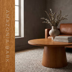Round pedestal coffee table finished in Evolve Amazonia Bark chestnut soy wood stain