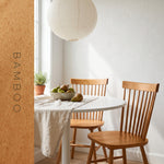 Spindle back dining chairs finished in Evolve Bamboo honey soy wood stain in a breakfast nook